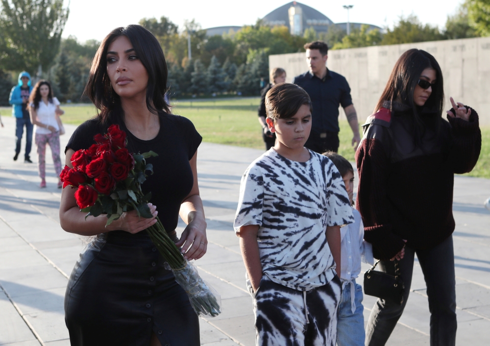 Reality TV personality Kim Kardashian, right, and her sister Kourtney Kardashian, left, with children visit Armenian Genocide Memorial in Yerevan, Armenia, on Tuesday. — Reuters