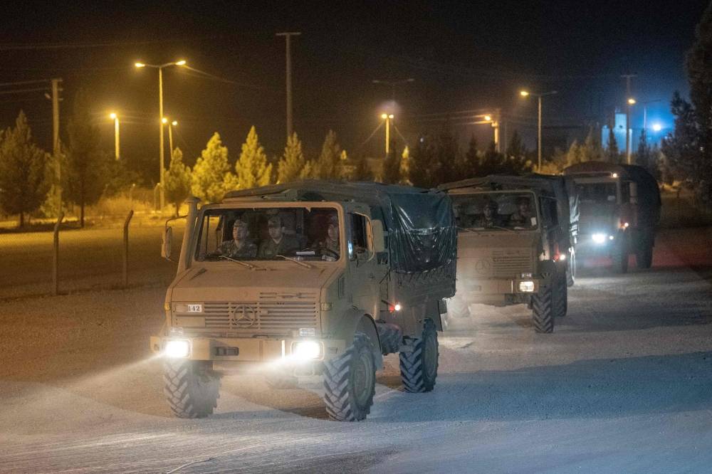 Turkish army soldiers drive towards the border with Syria near Akcakale in Sanliurfa province on Wednesday. — AFP