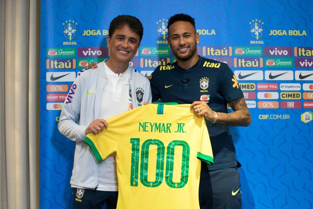 Handout picture released by the Brazilian Football Confederation (CBF) showing Brazilian football star Neymar (R) and former footballer Bebeto during a tribute to Neymar who is to make his 100th appearance with the national team in a friendly match against Senegal, during a press conference in Singapore, on Wednesday. Brazil will face Senegal on October 10 and Nigeria on October 13 in two friendly matches in Singapore. — AFP