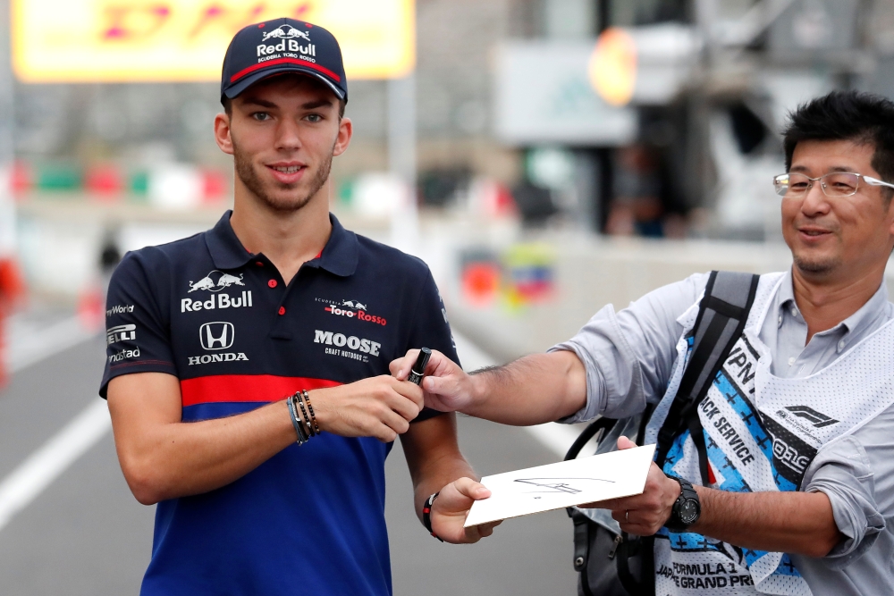 Toro Rosso's Pierre Gasly signs an autograph for a fan at Japanese Grand Prix in Suzuka, Japan, on Thursday. — Reuters