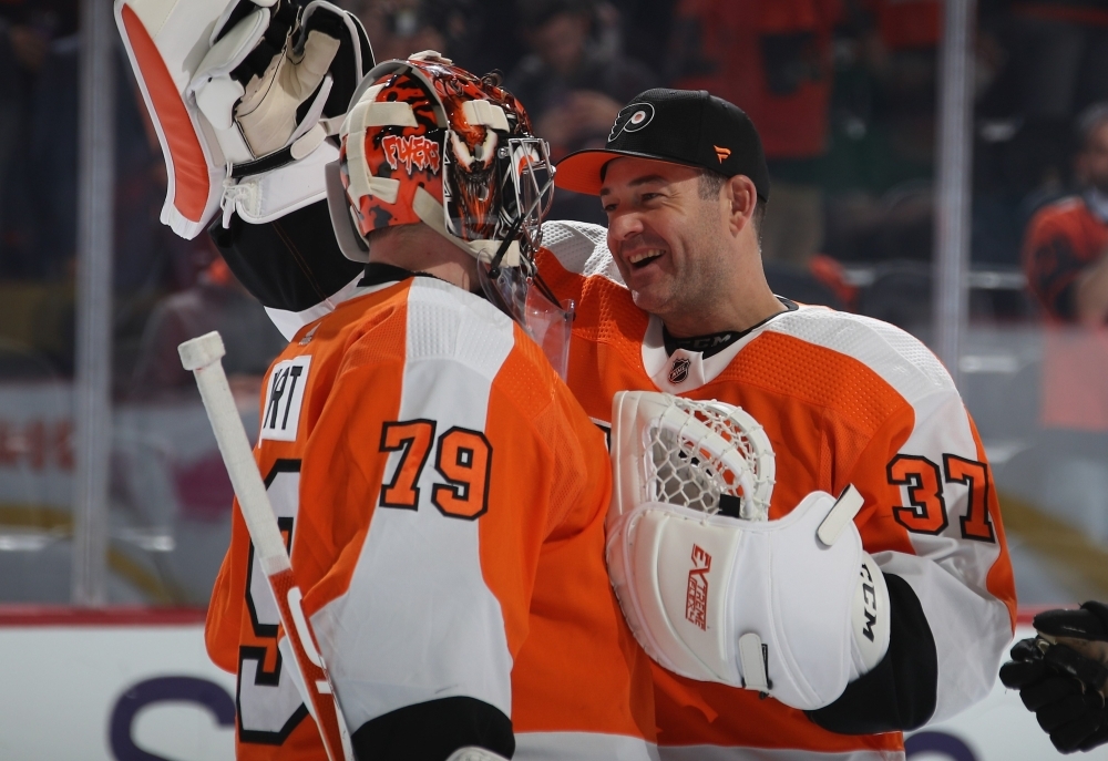 Carter Hart #79 of the Philadelphia Flyers celebrates his 4-0 shut-out against the New Jersey Devils along with Brian Elliott #37 at the Wells Fargo Center in Philadelphia, Pennsylvania, on Wednesday. — AFP