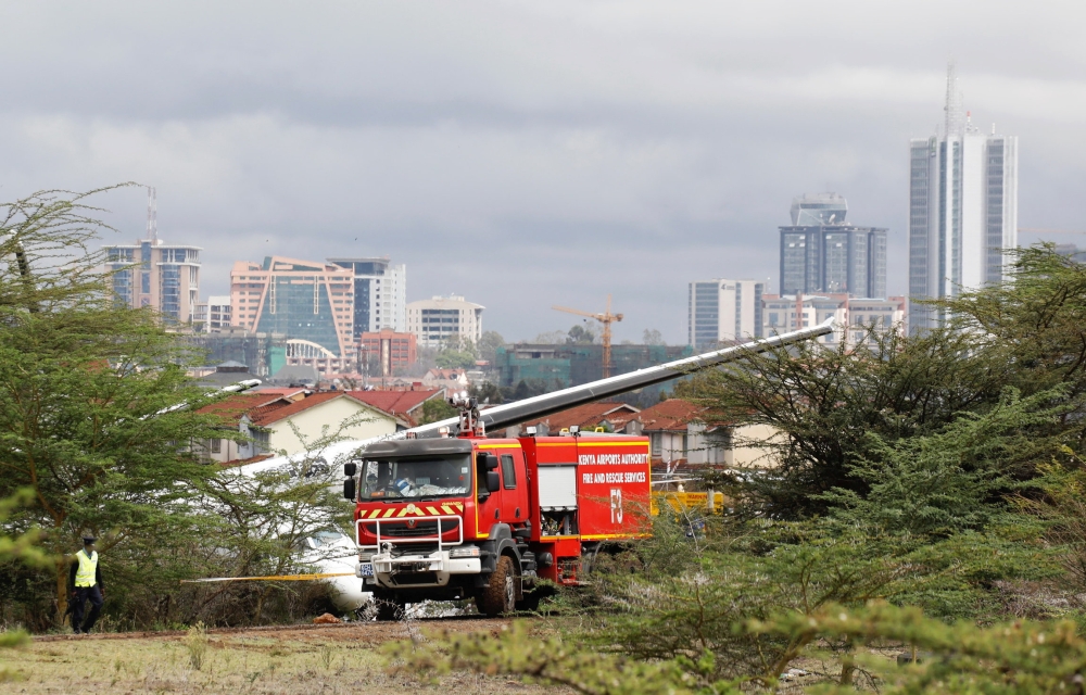 Bystanders watch the Fokker 50, 5Y-IZO plane operated by Silverstone Air that crash landed after take-off from the Wilson Airport in Nairobi, Kenya Friday. — Reuters