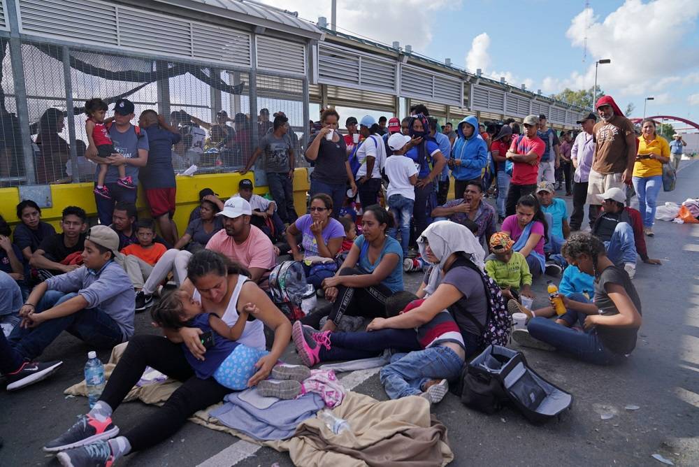A group of migrants who returned to Mexico to await their U.S. asylum hearing block the Puerta Mexico international border crossing bridge to demand quickness in their asylum process in Matamoros, Mexico October 10, 2019. -Reuters