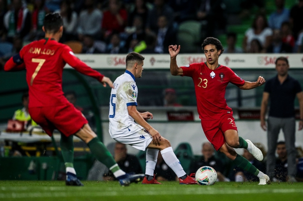 Portugal's forward Joao Felix (R) and Portugal's forward Cristiano Ronaldo (L) challenges Luxembourg's midfielder Olivier Thill during the Euro 2020 qualifier football match between Portugal and Luxembourg at the Jose Alvalade stadium in Lisbon, on Friday. — AFP