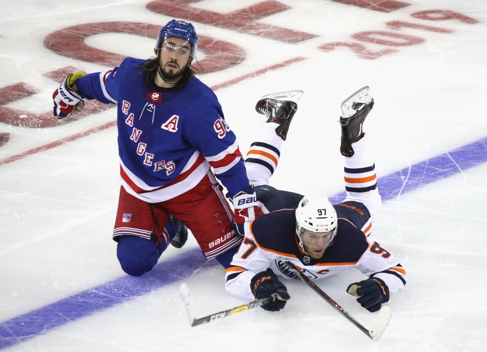 Connor McDavid #97 of the Edmonton Oilers is called for tripping Mika Zibanejad #93 of the New York Rangers during the third period at Madison Square Gardenin New York City, on Saturday. The Oilers defeated the Rangers 4-1. — AFP