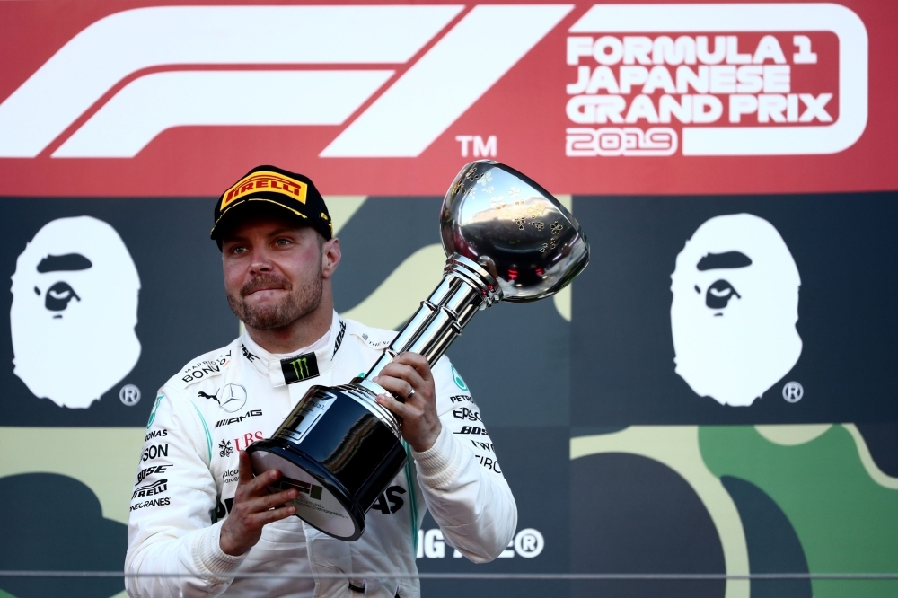 Mercedes' Finnish driver Valtteri Bottas celebrates his victory on the podium at the end of the Formula One Japanese Grand Prix final at Suzuka, on Sunday. — AFP