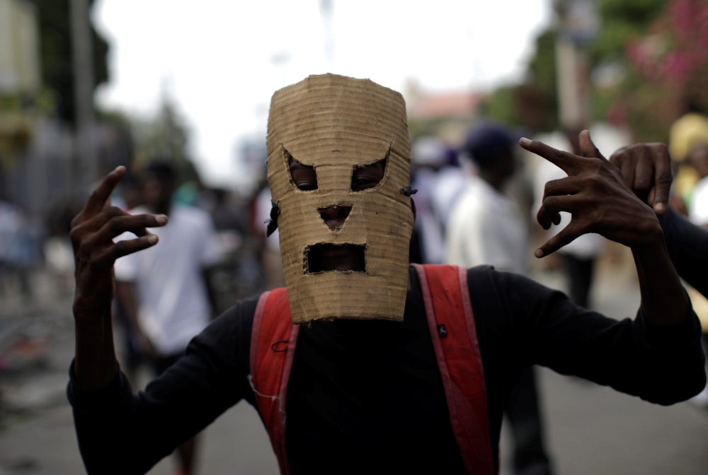 A protester gestures as he marches during a demonstration called by artists to demand the resignation of Haitian president Jovenel Moise, in the streets of Port-au-Prince, Haiti on Sunday. -Reuters