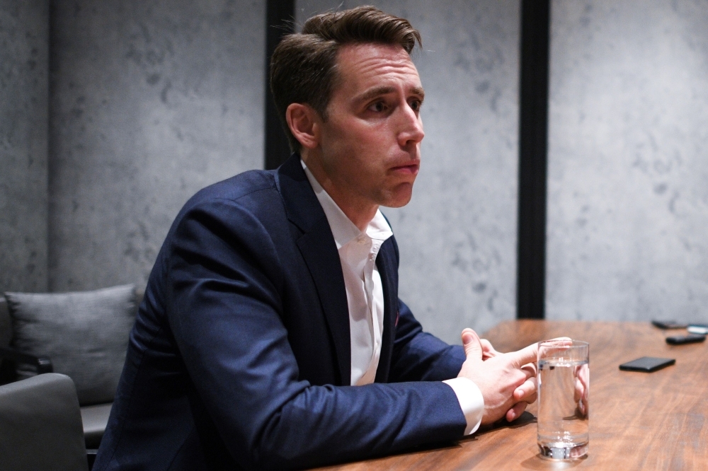 US Republican Senator from Missouri Josh Hawley listens to questions from members of the media at a hotel in Hong Kong on Monday.  -AFP