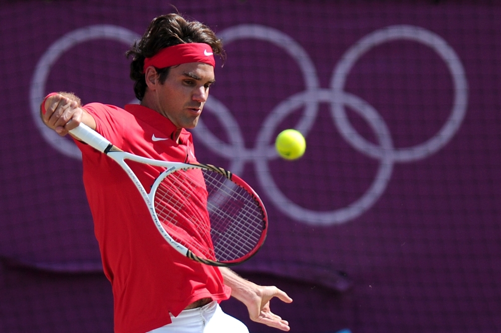 In this file photograph taken on Aug. 5, 2012, Switzerland's Roger Federer returns the ball to Britain's Andy Murray during their London 2012 Olympic Games men's singles gold medal tennis match at Wimbledon in south London. Roger Federer announced on Monday, that he will compete at the 2020 Olympic Games in Tokyo in the hope of winning the gold medal in singles, the only major title he lacks. — AFP