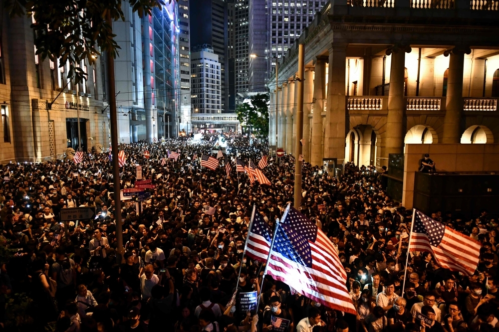 Protesters attend a rally in Hong Kong on Monday, calling on US politicians to pass a bill that could alter Washington's relationship with the trading hub. — AFP