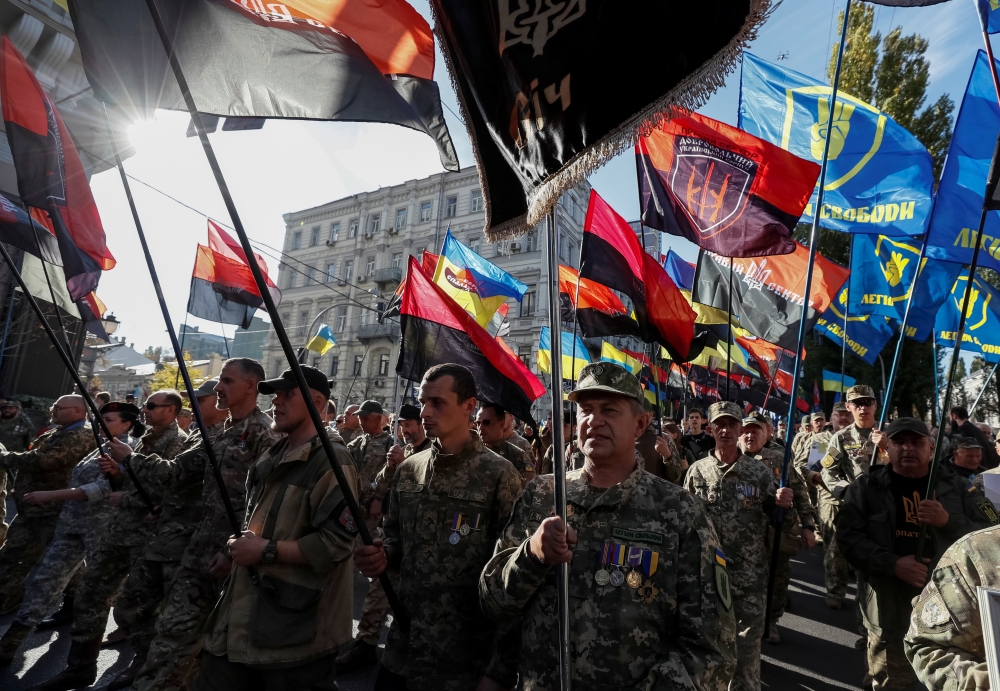 Veterans, activists and supporters of Ukraine's nationalist movements take part in a rally against the approval of the so-called Steinmeier Formula, in Kiev, Ukraine, on Monday. — Reuters