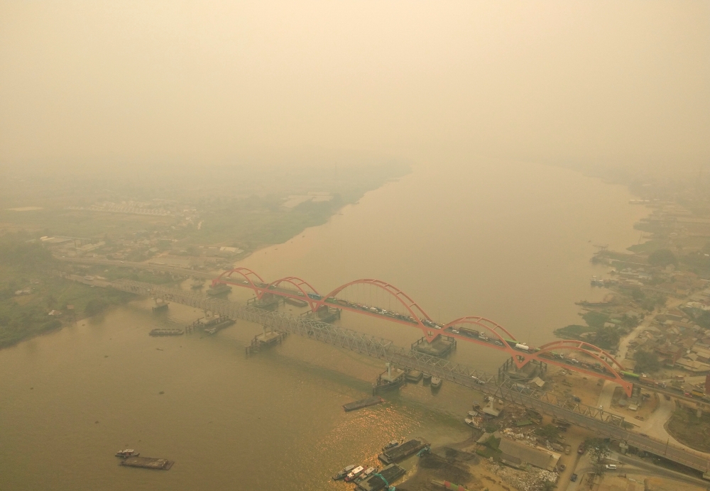 An aerial view of Palembang city covered by smoke from the forest fire in South Sumatra province, Indonesia, on Monday. -Reuters 