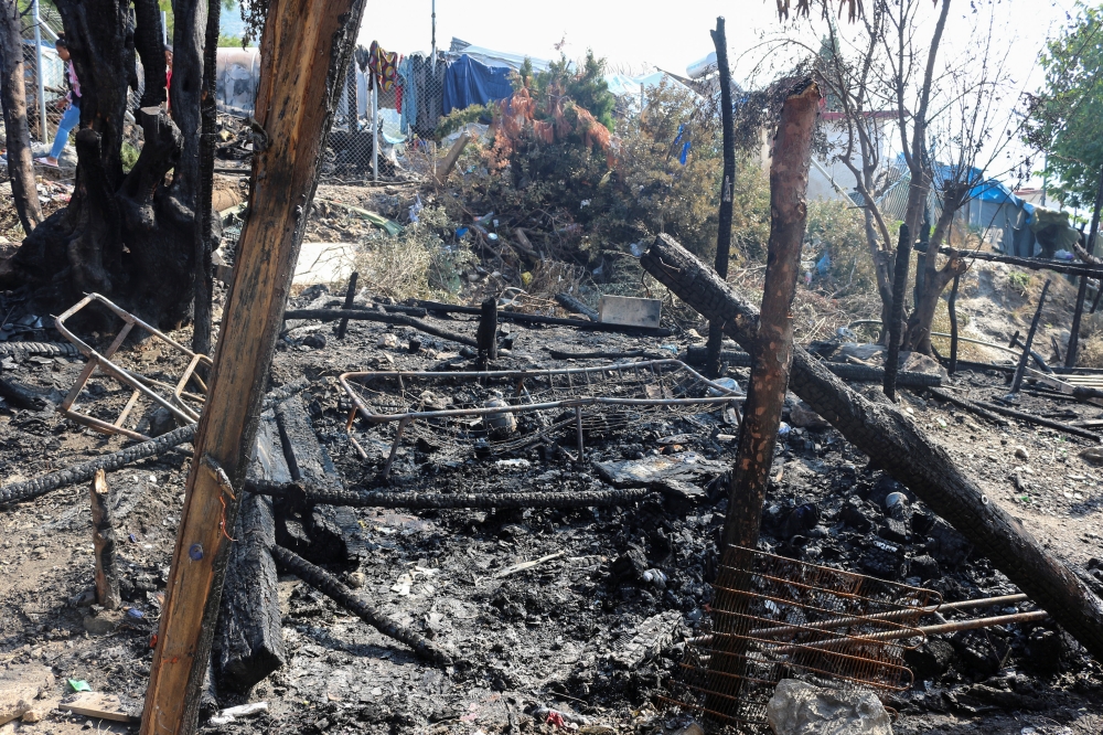 Burned beds and tents are seen at a camp for refugees and migrants following a fire on the island of Samos, Greece, on Tuesday. — Reuters