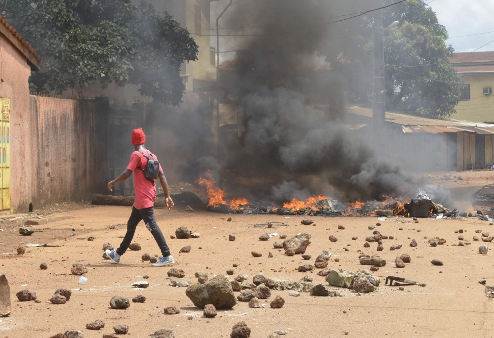 Protesters burn barricades and tires in Conakry street during a demonstration in Guinea on Monday. — AFP