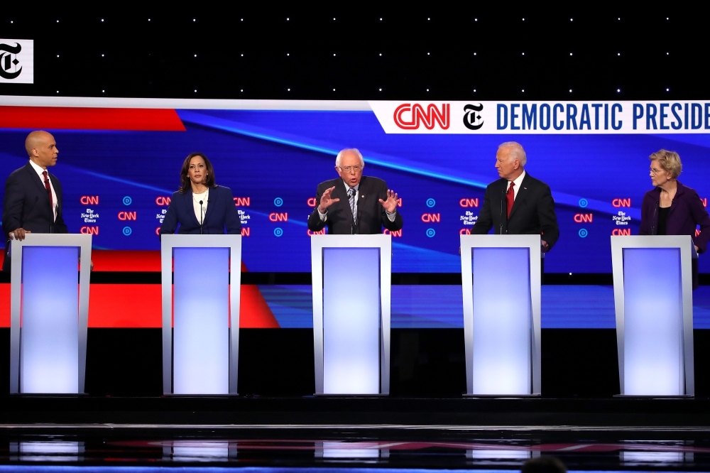 Sen. Cory Booker (D-NJ), left, Sen. Kamala Harris (D-CA), second left, Sen. Bernie Sanders (I-VT), center, former Vice President Joe Biden, second right, and Sen. Elizabeth Warren (D-MA), right, interact during the Democratic Presidential Debate at Otterbein University in Westerville, Ohio, on Tuesday. — AFP