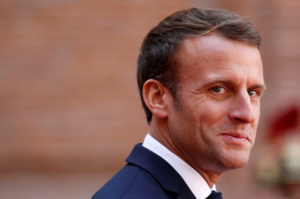 French President Emmanuel Macron welcomes German Chancellor Angela Merkel, not seen, before a joint Franco-German cabinet meeting in Toulouse, France, on Wednesday. — Reuters