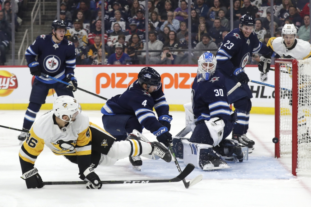 Pittsburgh Penguins center Zach Aston-Reese (46) scores on Winnipeg Jets goaltender Laurent Brossoit (30) in the first period at Bell MTS Place in Winnipeg, Manitoba, Canada, in this Oct. 13, 2019 file photo. — Reuters
