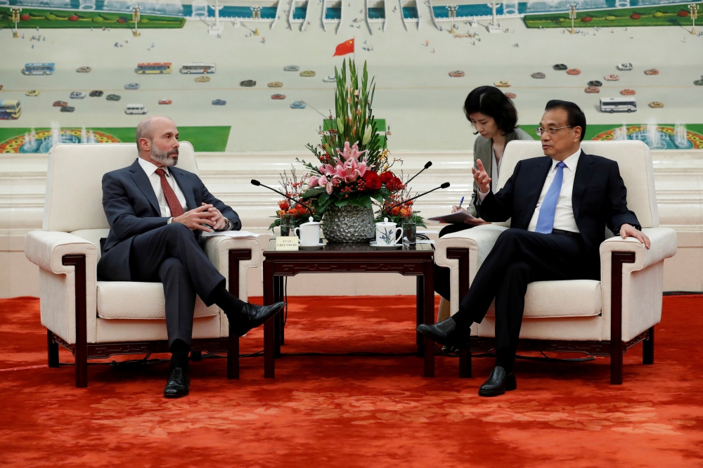 Chairman of the US-China Business Council Evan Greenberg, left, attends a meeting with Chinese Premier Li Keqiang, right, at the Great Hall of the People in Beijing on Thursday. — Reuters