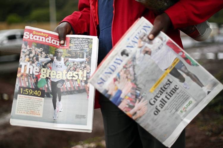 A newspaper vendor sells copies of local daily newspapers featuring Eliud Kipchoge, a Kenyan marathon athlete, in the newspaper headlines in Nairobi on Oct. 13, 2019.  World marathon record holder, Kipchoge, made it into the annals of history on Oct. 12 as the only man to have run a sub-two hour marathon, clocking 1:59:40.2 in the Austrian capital, Vienna at an event organized by British conglomerate Ineos, themed 1:59. — AFP