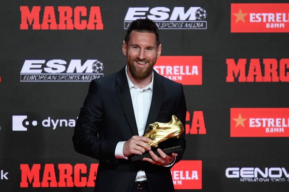 Barcelona's Argentinian forward Lionel Messi poses with his sixth Golden Shoe awards after receiving the 2019 European Golden Shoe honoring the year's leading goalscorer during a ceremony at the Antigua Fabrica Estrella Damm in Barcelona on Thursday. — AFP