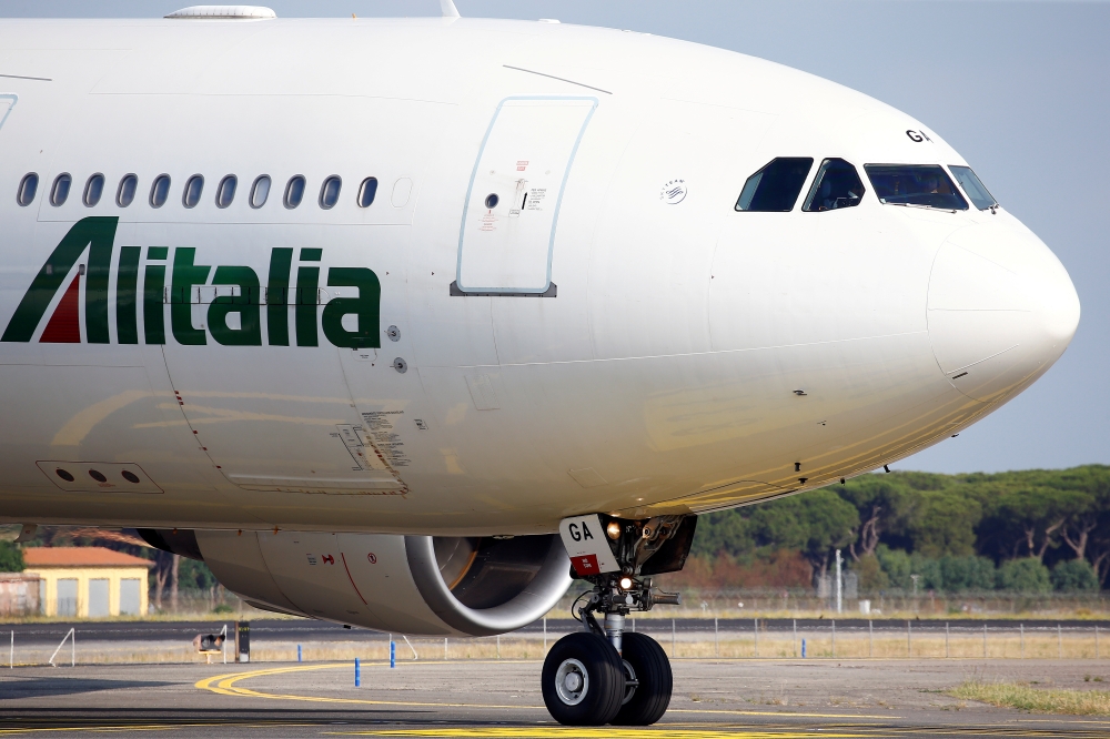 FILE PHOTO: An Alitalia airplane is seen before take off from the Leonardo da Vinci-Fiumicino Airport in Rome, Italy, June 21, 2018. REUTERS/Stefano Rellandini/File Photo
