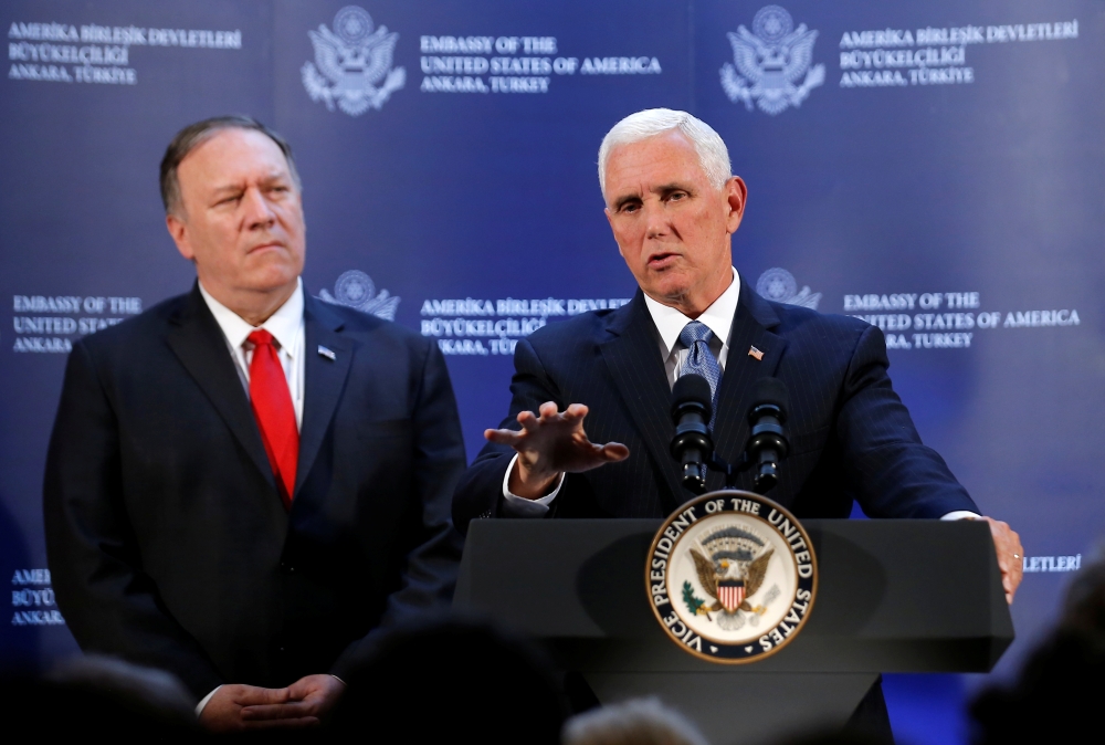 US Vice President Mike Pence speaks during a news conference, as US Secretary of State Mike Pompeo looks on, at the US Embassy in Ankara, Turkey, on Thursday. — Reuters