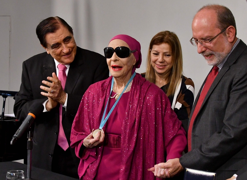 Cuban prima ballerina assoluta and director of Cuba's National Ballet Alicia Alonso (C) receives the doctorate Honoris Causa from the rector of the Universidad de Costa Rica (UCR) Henning Jensen, next to her husband Peter Simon (L) in San Jose on March 22, 2017.  — AFP