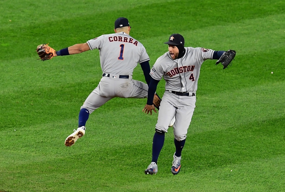 Carlos Correa No. 1 and George Springer No. 4 of the Houston Astros celebrate an 8-3 win of game four of the American League Championship Series against the New York Yankees at Yankee Stadium on Thursday in the Bronx borough of New York City. — AFP