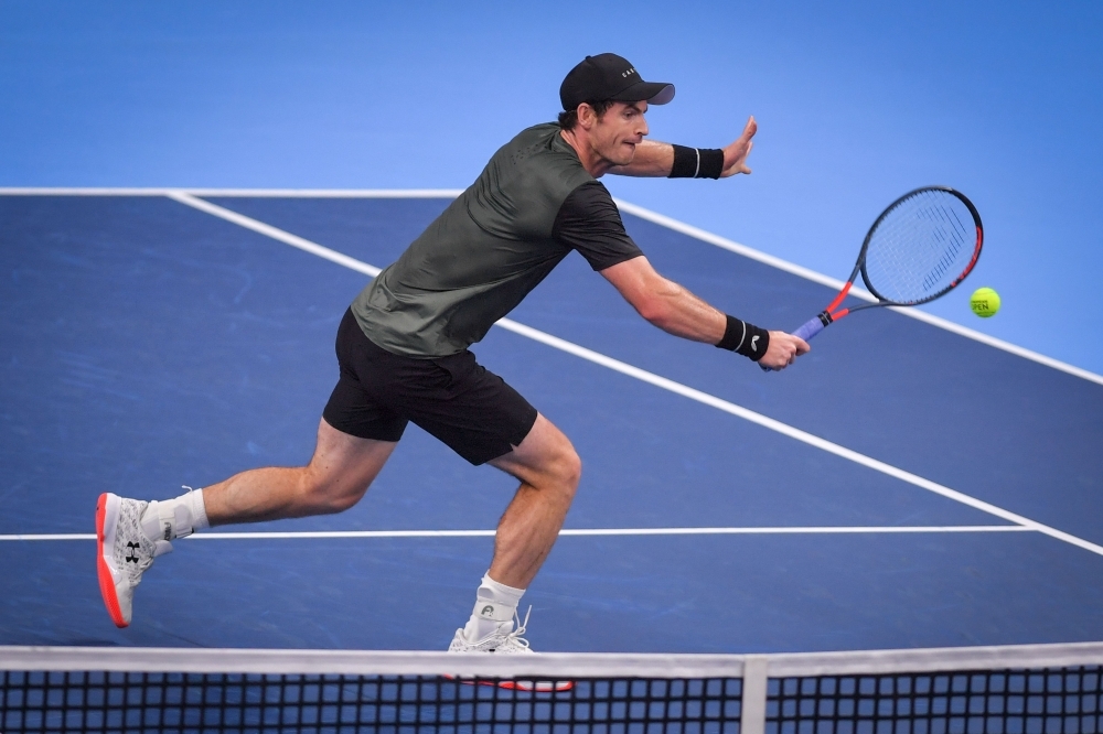 Britain's Andy Murray returns a shot during a tennis match against Uruguay's Pablo Cuevas, in the second round of the men's singles tournament at the European Open ATP Antwerp, on Thursday, in Antwerp.  — AFP