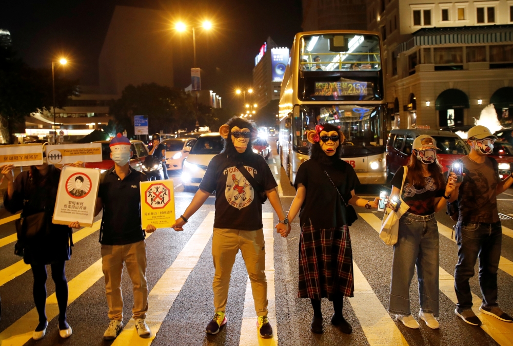 People wearing masks gather during an anti-government protest in Hong Kong, China, on Friday. — Reuters