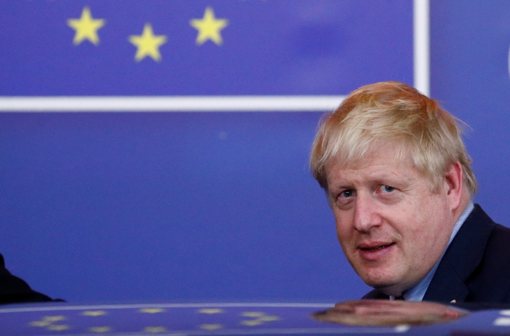 Britain's Prime Minister Boris Johnson leaves the European Council after the Brexit-dominated European Union leaders summit in Brussels, Belgium, on Friday. — Reuters