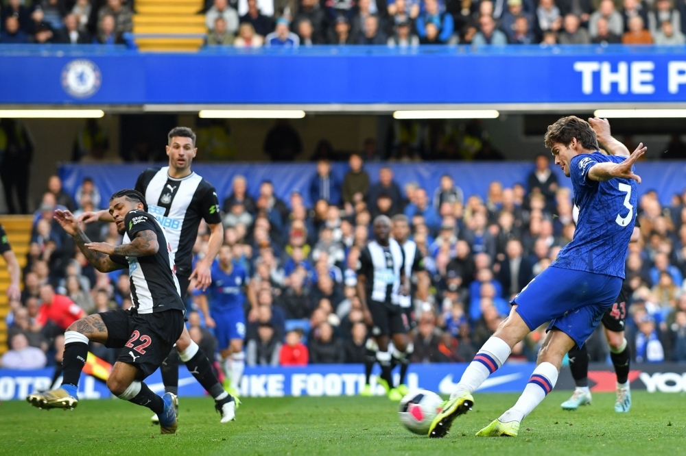 Chelsea's Spanish defender Marcos Alonso (R) shoots to score the opening goal of the English Premier League football match between Chelsea and Newcastle at Stamford Bridge in London, on Saturday. — AFP