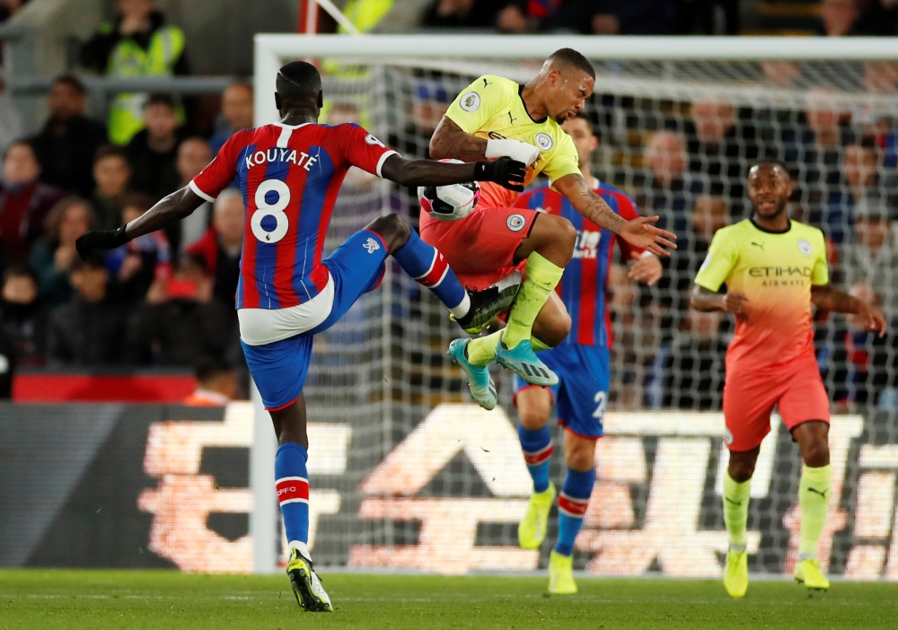 Crystal Palace's Cheikhou Kouyate in action with Manchester City's Gabriel Jesus at Selhurst Park, London, Britain, on Saturday. — Reuters