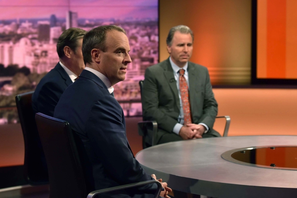 In a handout picture released by the BBC Britain's Foreign Secretary and First Secretary of State Dominic Raab (C), Britain's main opposition Labour Party shadow Secretary of State for Exiting the EU Keir Starmer (L) and former Conservative Party MP, now Independent, Oliver Letwin (R) appear on the BBC political program The Andrew Marr Show in London on Sunday.  Britain will leave the European Union on time on Oct. 31, the government insisted Sunday after MPs voted to force the Prime Minister into seeking yet another delay. Johnson reluctantly sent European Council President a letter legally imposed on him by parliament requesting an extension — but refused to sign it. — AFP