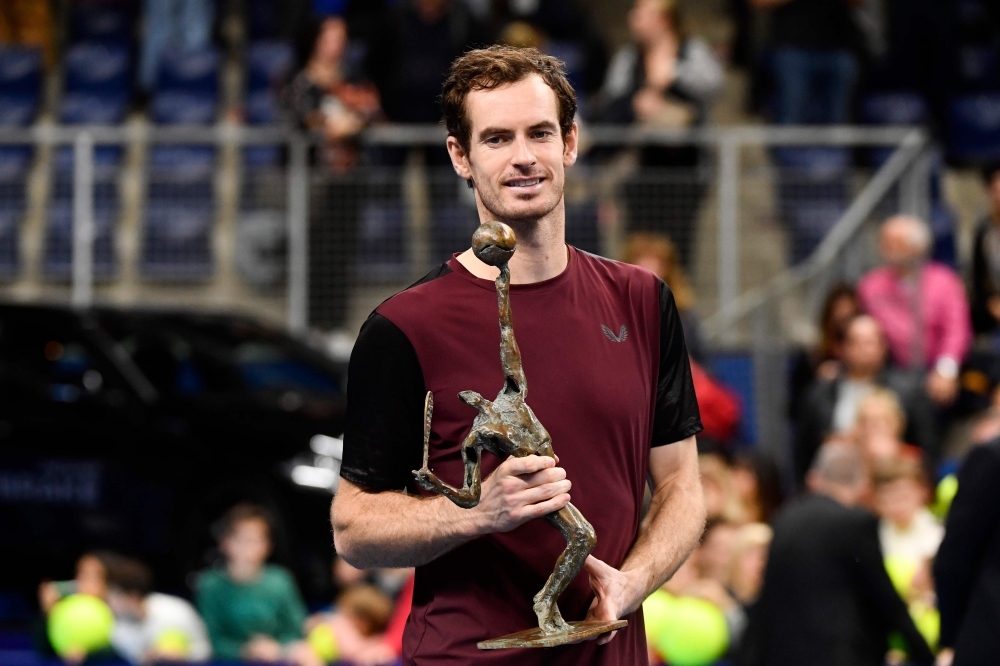 Britain's Andy Murray celebrates with the trophy after winning against Switzerland's Stanislas Wawrinka in their men's single tennis final match of the European Open ATP Antwerp, on Sunday in Antwerp. — AFP