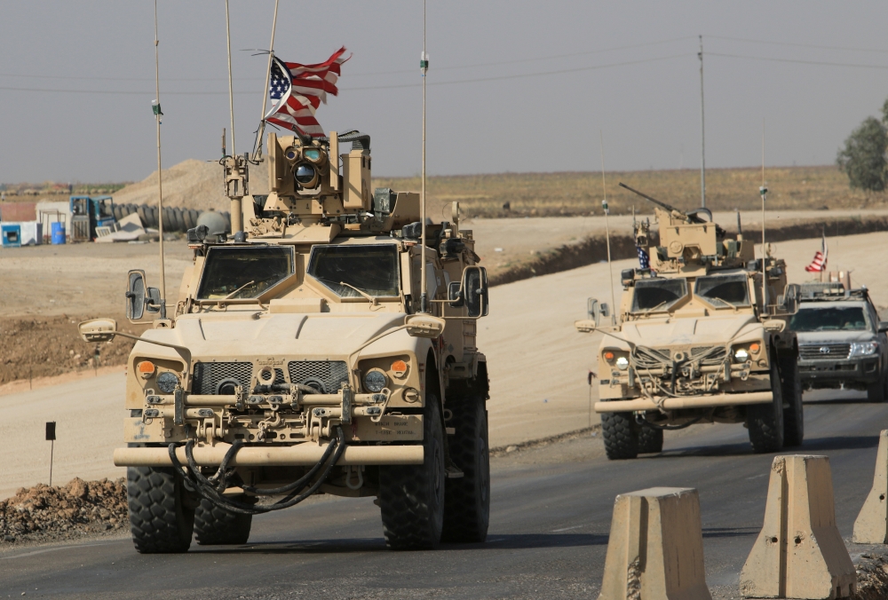 A convoy of US vehicles is seen after withdrawing from northern Syria, at the Iraqi-Syrian border crossing in the outskirts of Dohuk,, Iraq, on Monday. — Reuters