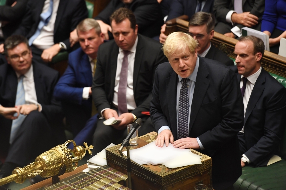 A handout picture released by the UK Parliament shows Britain's Prime Minister Boris Johnson, right, speaking in the House of Commons in London on Oct. 19, 2019, during a debate on the Brexit deal. — AFP