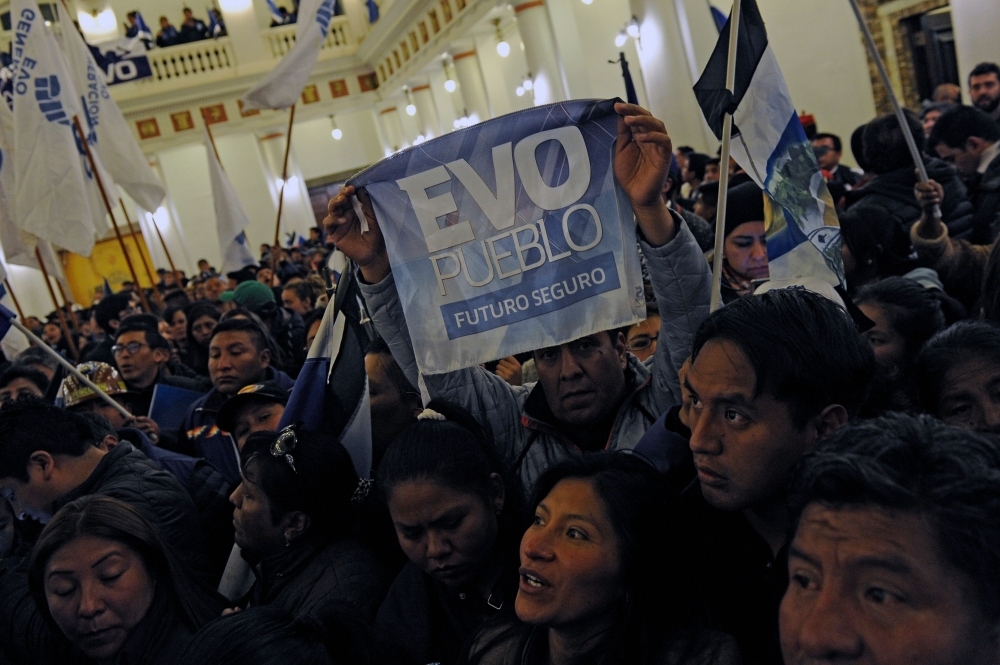 Supporters of Bolivian President and presidential candidate for the Movimiento al Socialismo (MAS) Evo Morales celebrate after knowing the partial results of the general elections at Quemado presidential palace in La Paz on Sunday. — AFP