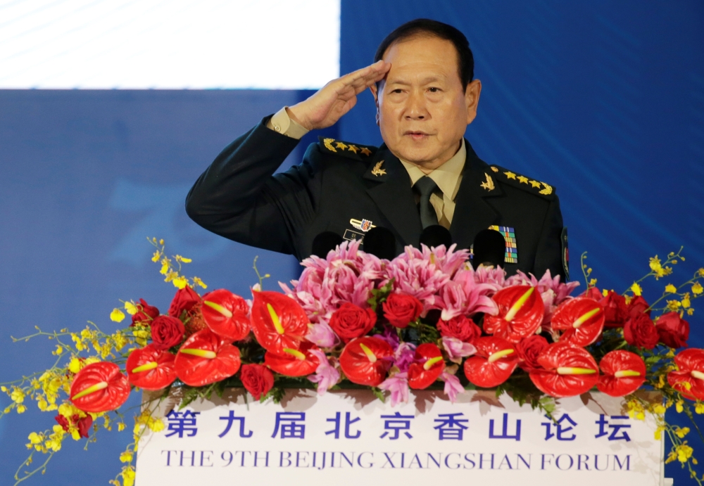Chinese Defense Minister Wei Fenghe salutes before a speech at the Xiangshan Forum in Beijing, China, on Monday. — Reuters