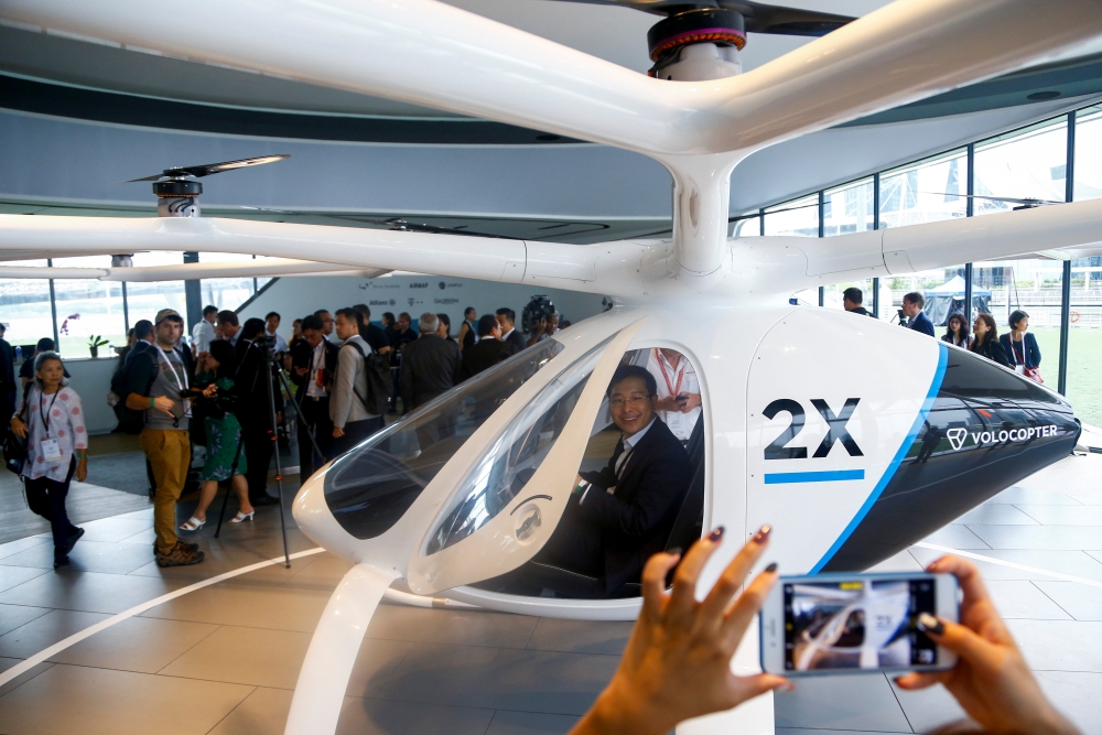 A Volocopter unmanned air taxi transport flies over Marina Bay during test flight with a safety pilot at the 26th Intelligent Transport Systems World Congress (ITSWC) in Singapore on Tuesday. — AFP