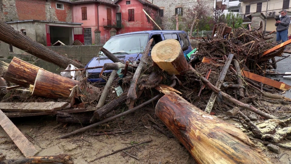 A van and debris are seen piled up next to a bridge in stream after flash floods in Castelletto D'Orba, Italy, on Tuesday. — Reuters