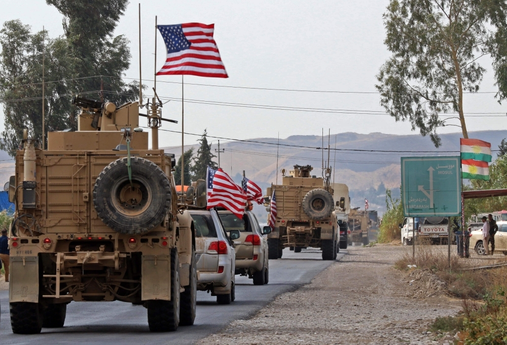 A convoy of US military vehicles arrives near the Iraqi Kurdish town of Bardarash in the  Dohuk governorate after withdrawing from northern Syria on Monday. — AFP