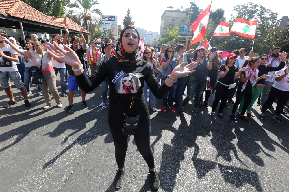 Demonstrators march during an anti-government protest in the southern city of Tyre, Lebanon, Tyre, where Hezbollah holds sway, on Tuesday. — Reuters