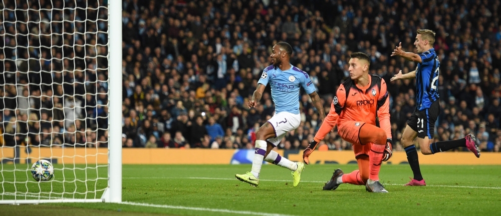 Manchester City's English midfielder Raheem Sterling (L) scores their fifth goal to complete his hattrick during the UEFA Champions League Group C football match between Manchester City and Atalanta at the Etihad Stadium in Manchester, northwest England, on Tuesday. — AFP