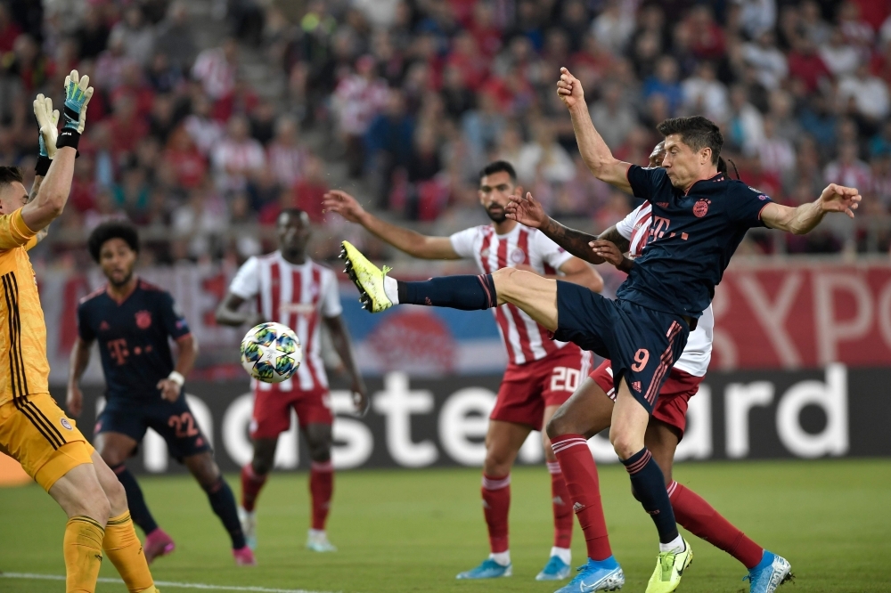 Bayern Munich's Polish forward Robert Lewandowski scores a goal during the UEFA Champions League group B football match between Olympiacos FC and FC Bayern Munchen at the Georgios Karaiskakis stadium in Piraeus near Athens, on Tuesday. — AFP