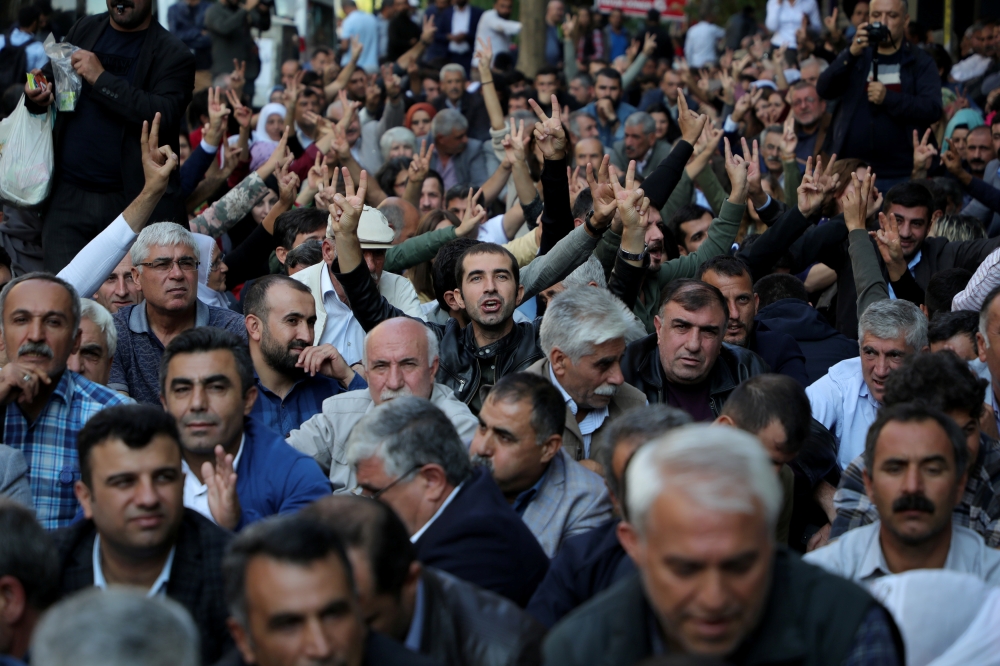 Supporters of Pro-Kurdish Peoples' Democratic Party (HDP) gather to protest against the detention of their local politicians in Diyarbakir, Turkey, on Wednesday. — Reuters