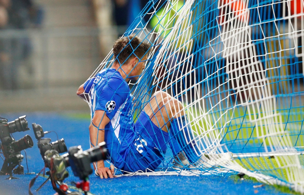 KRC Genk's Joakim Maehle in the goal net after Liverpool's third goal during the UEFA Champions League Group E football match on Wednesday at the Luminus Arena in Genk. — Reuters