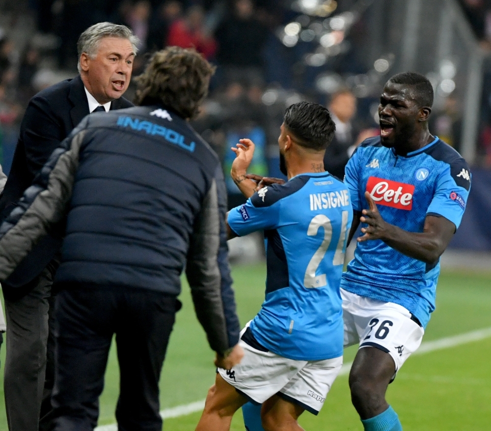 Napoli's Italian head coach Carlo Ancelotti (L) and Napoli's Italian forward Lorenzo Insigne (2nd R) celebrate scoring the 2-3 during the UEFA Champions League Group E football match against Salzburg on Wednesday in Salzburg, Austria. — AFP