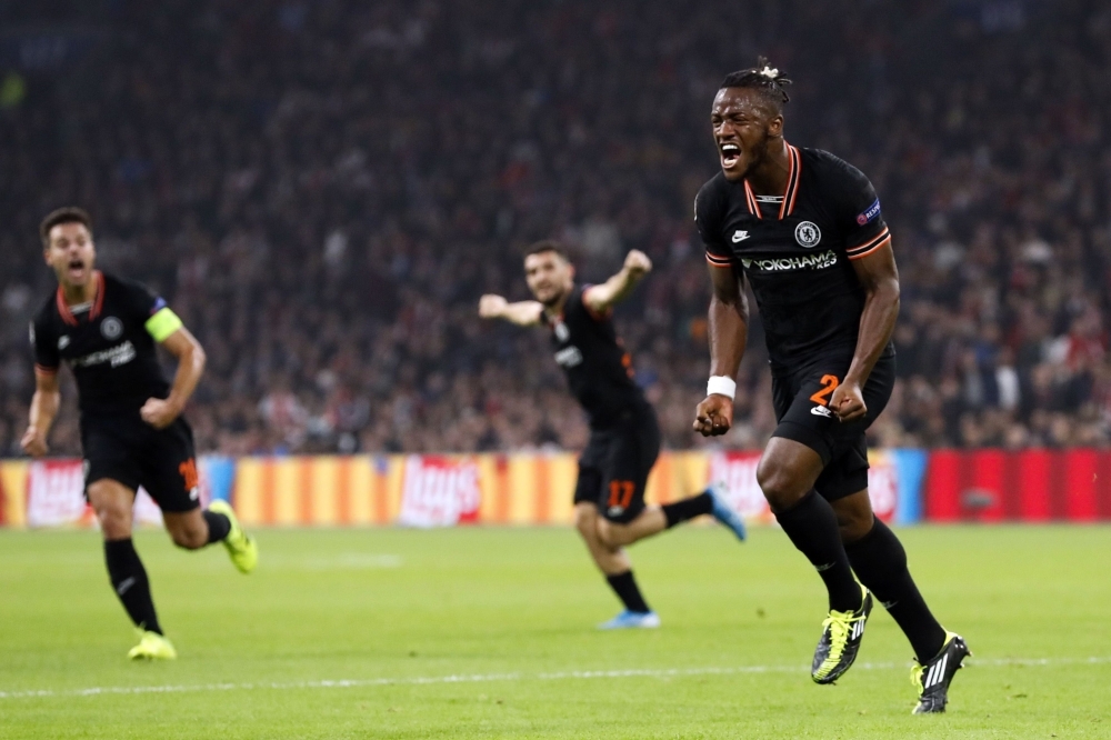 Chelsea's Belgian striker Michy Batshuayi (R)celebrates after scoring a goal during the UEFA Champions League Group H football match between Ajax Amsterdam and Chelsea on Wednesday at the Johan Cruijff Arena, in Amsterdam. — AFP