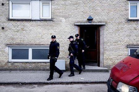 Policemen walk out from an apartment block during a search for suspects believed to have traveled to Syria to join Daesh, in Tingbjerg, Copenhagen, in this April 7, 2016 file photo. — Reuters